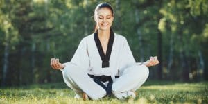 Martial Arts Lessons for Adults in Cypress TX - Happy Woman Meditated Sitting Background